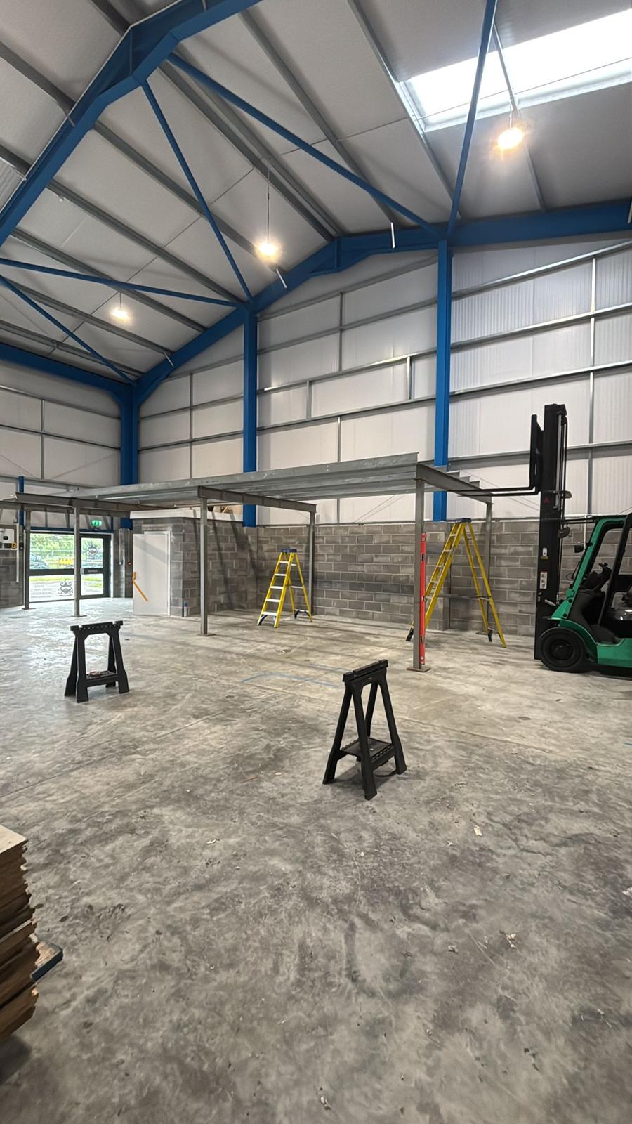 Bare steel mezzanine frame erected in an empty industrial unit