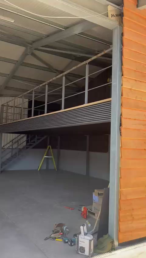 Mezzanine deck edge with handrail and staircase in a small industrial unit